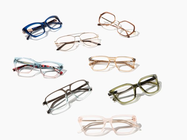 Colorful pairs of glasses laying on a flat surface