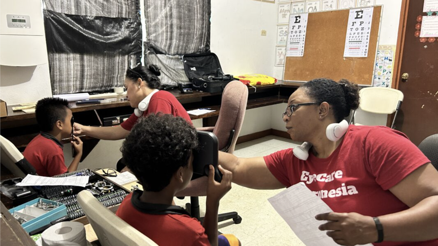 Dr. Hellan-Pangelinan provides an exam to a child in Micronesia