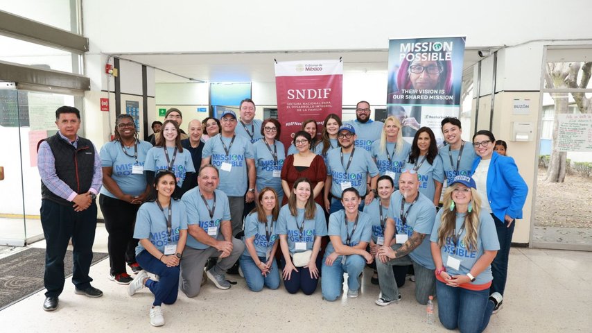 Group of volunteers posing for a photo during a Mission Possible community outreach event.