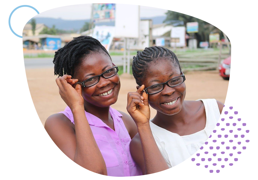 two girls smiling while wearing glasses